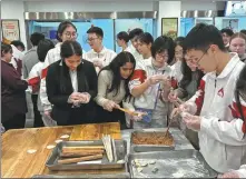  ?? PHOTO PROVIDED TO CHINA DAILY ?? Muscatine students learn how to make dumplings in Beijing during their 10- day trip to China in January.