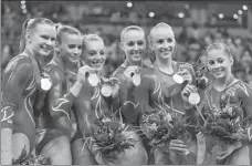 ?? AP ?? Chellsie Memmel (third from right) and her US teammates pose with their silver medals after the women’s team final at the Beijing Olympics on Aug 13, 2008.