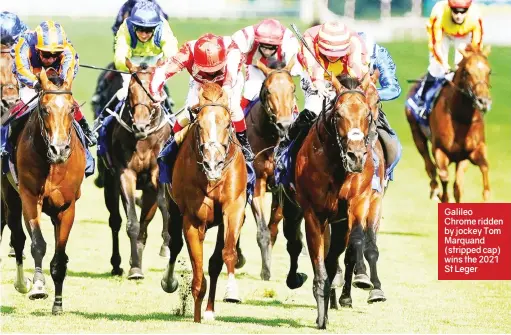  ?? ?? Galileo Chrome ridden by jockey Tom Marquand (stripped cap) wins the 2021 St Leger