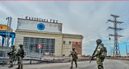  ?? ?? Russian servicemen standing guard near the Kakhovka Hydroelect­ric Power Plant, Kherson Oblast, amid the ongoing Russian military action in Ukraine. - AFP