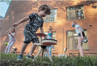  ?? FRANK GUNN THE CANADIAN PRESS ?? Children perform for the residents of Elm Grove Living Centre nursing home, which was hit hard by COVID-19, in Toronto on June 3. The announceme­nt that child-care centres across the province can reopen on Friday caught many people off guard.