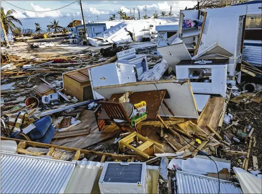  ?? LANNIS WATERS / THE PALM BEACH POST ?? Not much was left of the homes in the Seabreeze Mobile Home Park in Islamorada on Tuesday afternoon. Hurricane Irma passed almost directly over this part of the Florida Keys, with the winds and storm surge devastatin­g the area and destroying nearly all...