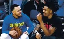  ?? DOUG DURAN — BAY AREA NEWS GROUP FILE ?? The Golden State Warriors’ Stephen Curry, left, talks with the Atlanta Hawks’ Kent Bazemore before the start of their game at Oracle Arena in Oakland on March 23, 2018.