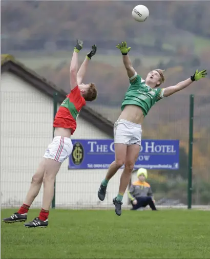  ??  ?? JT Moorehouse of Rathnew and Sean Branagan of St Nicholas battle for a high battle during their U-20 Championsh­ip match.