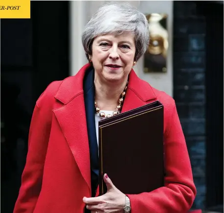  ?? JACK TAYLOR / GETTY IMAGES ?? British Prime Minister Theresa May leaves 10 Downing Street on Tuesday, as three successive failed votes put her plans for Brexit in danger and her position as party leader — and prime minister — on shakier ground.