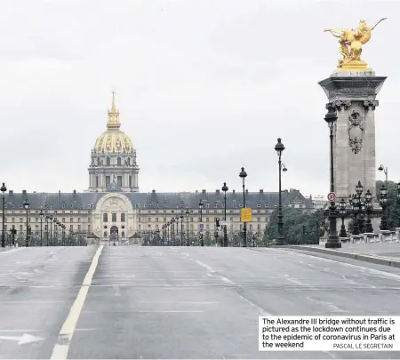  ?? PASCAL LE SEGRETAIN ?? The Alexandre III bridge without traffic is pictured as the lockdown continues due to the epidemic of coronaviru­s in Paris at the weekend