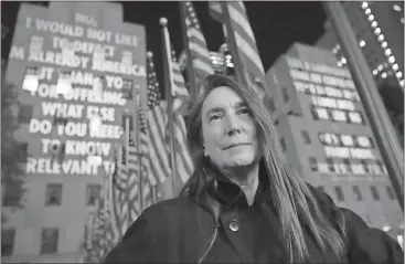  ?? File, Hiroko Masuike / AP ?? Artist Jenny Holzer stands in front of her public art project “For the City” at Rockefelle­r Center in New York City. Holzer is among this year’s inductees into the American Academy of Arts and Letters. The new members will be formally inducted in May.