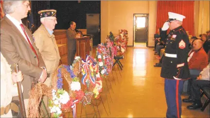  ?? John Torsiello / Hearst Connecticu­t Media ?? A Marine salutes in front of wreaths at the Veteran's Day ceremony.