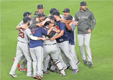  ??  ?? Red Sox players celebrate on the field in Houston after defeating the Astros in the ALCS to advance to the World Series. ERIK WILLIAMS/USA TODAY SPORTS