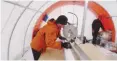  ??  ?? Researcher Liz Thomas is pictured measuring a newly drilled ice core in Antarctica. UPI