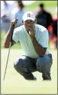  ?? AP/The Philadelph­ia Inquirer/ JOSE F. MORENO ?? Tiger Woods lines up a putt on the ninth green Thursday during the first round of the BMW Championsh­ip golf tournament at Aronimink Golf Club in Newtown Square, Pa.