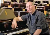  ??  ?? In this picture Maestro Massimo Palombella poses for photos with the piano that used to belong to Cardinal Joseph Ratzinger and that he donated to the Sistine Chapel choir when he was elected Pope Benedict XVI, after an interview with the Associated...