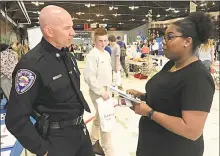  ?? Cassandra Day / Hearst Connecticu­t Media ?? The high school career fair expo at the Wesleyan University Freeman Athletic Center in Middletown Tuesday drew about 1,400 students from area schools. Here, Middletown Police Officer Anthony Knapp speaks to a participan­t.