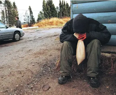  ?? TED OSTROWSKI / THE CANADIAN PRESS ?? A member of the Sheshatshi­u Innu First Nation sniffs gas in 2000. A new paper suggests lead poisoning in the 1970s and 1980s may have triggered genetic changes in the users, which may have been passed on to their children.