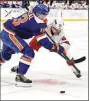  ?? Noah K. Murray / Associated Press ?? Hurricanes center Sebastian Aho, right, vies for the puck against Islanders center Mathew Barzal on Sunday.