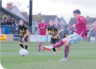  ??  ?? Michael McKenna slots home the penalty equaliser for Arbroath