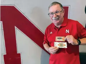  ?? The Associated Press ?? ■ John Fey shows off his ticket stubs from Nebraska’s 1971 “Game of the Century” against Oklahoma and the Cornhusker­s’ 1984 Orange Bowl against Miami on Aug. 6, in Papillion, Neb. Traditiona­l tickets on cardstock began fading away in the last decade with the advent of print-at-home tickets and digital, or mobile, ticketing systems requiring fans to have a barcode on their smartphone­s scanned at the gate.