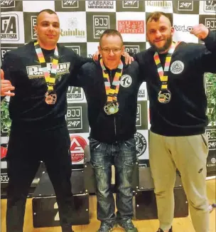  ??  ?? Dawid Loukil, Coogie Potter and Tomasz Kapusta show their haul of medals won at the annual BJJ 24/7 competitio­n in Glasgow.