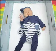  ?? DAVID JALA/CAPE BRETON POST ?? Madison Keating was the first Cape Breton newborn to get her very own Baby Box. The four-week-old took to the sleeping box immediatel­y after being placed in it by dad Matt Keating and mom Theresa O’Brien, who has been under the care of local...