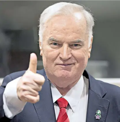  ??  ?? No remorse: Ratko Mladić gave a thumbs-up to photograph­ers as he waited for the verdict. He was later removed from the court after screaming abuse