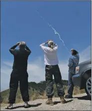  ?? AP/The Santa Maria Times/LEN WOOD ?? Spectators near Lompoc, Calif., watch an intercepto­r missile launched Tuesday from Vandenberg Air Force Base.