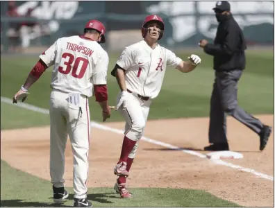  ?? (NWA Democrat-Gazette/Charlie Kaijo) ?? Arkansas second baseman Robert Moore heads for the plate after hitting a fourth-inning home run Sunday in an 11-10 loss to Texas A&M at Baum-Walker Stadium in Fayettevil­le. The loss snapped a five-game winning streak for the No. 1 Razorbacks. More photos at arkansason­line.com/419tamua/