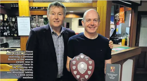  ??  ?? ● Caernarfon’s Simon Davis (right), pictured receiving a previous Bowler of the season award, was in exceptiona­l form in the crushing win against Marchwiel, and Wrexham, taking 5-1 with seven maidens