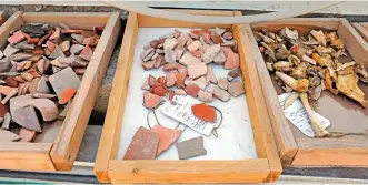  ??  ?? Bones and pieces of ceramic found by Israeli archeologi­sts are seen at the site.