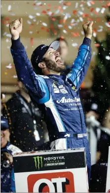  ?? Colin E. Braley / The Associated Press ?? Martin Truex Jr. celebrates in Victory Lane after winning the NASCAR Monster Cup auto race at Kansas Speedway in Kansas City.