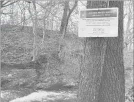  ??  ?? A sign alerts visitors to report anything unnatural about Deep Brook to the Citizen River Watch.