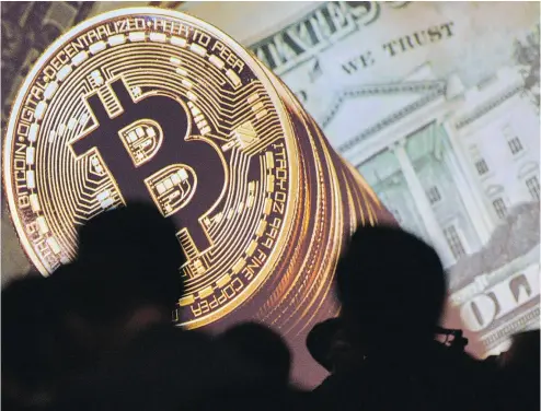  ?? ROSLAN RAHMAN / AFP / GETTY IMAGES ?? As recently as December, bitcoin was trading at less than US$1,000. Since then, it has dodged everything from tightening regulation­s, feuding factions and warnings from the likes of JPMorgan Chase chief executive Jamie Dimon of fraud.