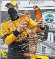  ?? Charles Krupa The Associated Press ?? Brad Keselowski holds the ceremonial giant lobster to celebrate his NASCAR Cup win Sunday at New Hampshire Motor Speedway.