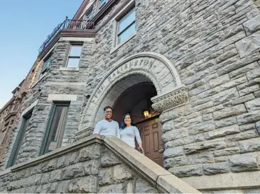  ?? BALTIMORE SUN STAFF ?? Sal and Meenu Choudhary on the front steps of a former Mount Vernon mansion known over the years as the Charles Royal and the Halburton. They purchased the building for $1.25 million.