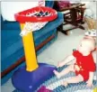  ?? COURTESY PHOTO ?? Ty Tice swishes a golf ball through a Little Tikes basketball goal as a baby. His first word was, “ball.”