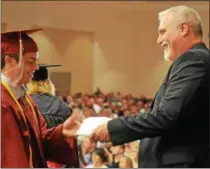  ?? NICHOLAS BUONANNO — NBUONANNO@DIGITALFIR­STMEDIA.COM ?? Stillwater School District’s Board of Education President Timothy Hems hands a diploma to a student during commenceme­nt Saturday.