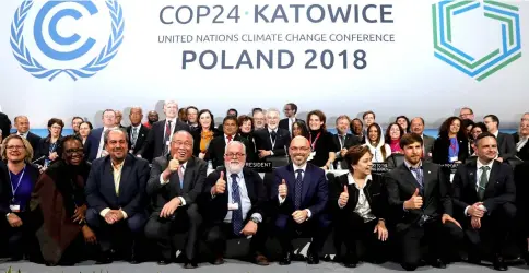  ??  ?? Kurtyka (front, fourth right) and executive secretary of the UN Framework Convention on Climate Change Patricia Espinosa (third right) pose with the heads of delegation­s after adopting the final agreement during a closing session of the COP24 UN Climate Change Conference 2018 in Katowice. — Reuters photo