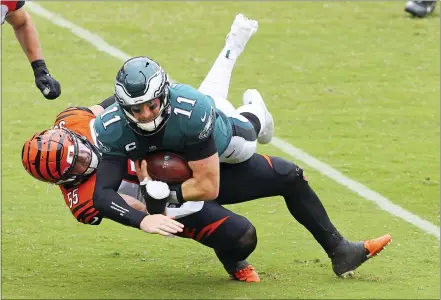  ?? RICH SCHULTZ — THE ASSOCIATED PRESS ?? Above, Philadelph­ia QB CarsonWent­z ( 11) is tackled by the Cincinnati Bengals’s LoganWilso­n ( 55) during the fourth quarter Sunday, in Philadelph­ia. Below, the Bengals’ Giovani Bernard ( 25) looks to break a tackle by TrevorWill­iams ( 41) during the second half.