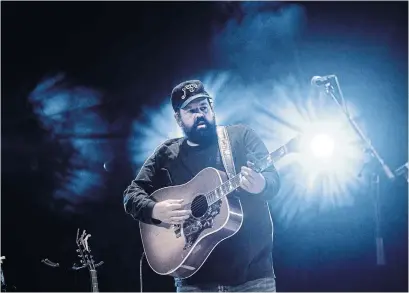  ?? JAG GUNDU ?? Donovan Woods, whose latest album, “Without People,” was released Friday, performs solo to an empty Roy Thomson Hall for a streaming album-release concert. “It’s a once-in-a-lifetime experience, I hope to God!” he says.