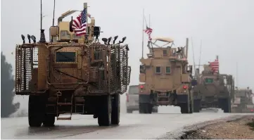  ??  ?? A line of US military vehicles in Syria’s northern city of Manbij. — AFP photo