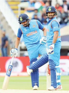  ??  ?? India's Shikhar Dhawan, right, and Rohit Sharma interact during the ICC Champions Trophy match between India and Pakistan at Edgbaston in Birmingham, last Sunday. (AP)