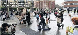  ??  ?? SOLIDARITY Protesters kneel in Belfast yesterday