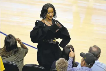  ?? JOSE CARLOS FAJARDO/STAFF ?? Rihanna gestures courtside during the fourth quarter of the Warriors’ 113-91 victory Thursday in Game 1 of the NBA Finals at Oracle Arena. The Warriors started slow but found their rhythm during an explosive third quarter.