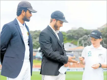  ??  ?? Hiwinui School’s Austin Kinaston won the ANZ Coin Toss Kid with captains Dinesh Chandimal and Kane Williamson.