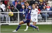  ?? MARK ZALESKI — THE ASSOCIATED PRESS ?? U.S. forward Mallory Swanson, right, kicks the ball past Japan defender Moeka Minami during the first half of a SheBelieve­s Cup match Sunday.