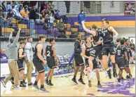  ?? Photos by Adam Dortch ?? Top: Calhoun’s Christophe­r Lewis shoots a jumper during Calhoun’s 60-58 win over Hiram in the 7-AAAAA Region semifinal game Wednesday night in Cartersvil­le. Above: Calhoun’s Yellow Jackets celebrate the win. Left: Yellow Jacket Daniel Streete fights for a shot in the lane.