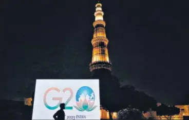  ?? SANCHIT KHANNA/HT PHOTO ?? The G20 logo displayed near the Qutub Minar on Thursday as India officially took over the presidency of the grouping.