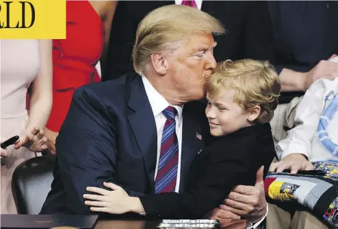  ?? EVAN VUCCI / THE ASSOCIATED PRESS ?? President Donald Trump kisses Jordan McLinn, a Duchenne Muscular Dystrophy patient, after signing the “Right to Try” act in the South Court Auditorium on the White House campus in Washington on Wednesday.