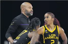  ?? MARK J. TERRILL – THE ASSOCIATED PRESS ?? Sparks head coach Derek Fisher, talking with guards Erica Wheeler and Te’a Cooper, right, is hopeful that his team can shake its losing streak and get back to full health.