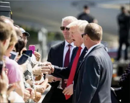  ?? THE ASSOCIATED PRESS ?? President Donald Trump greets guests on the tarmac after he arrived on Air Force One at General Mitchell Internatio­nal Airport in Milwaukee, Wis. on Tuesday.