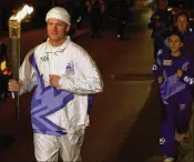  ?? CHARLOTTE OBSERVER ?? Dale Earnhardt Jr. (in the Olympic torch relay in 2001) is retired but will serve as grand marshal for the Daytona 500 and be part of NBC’s team.